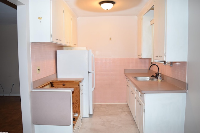 22800 Beaconsfield Ave, Eastpointe, MI 48021 - kitchen featuring freestanding refrigerator, a sink, tile walls, white cabinets, and light countertops