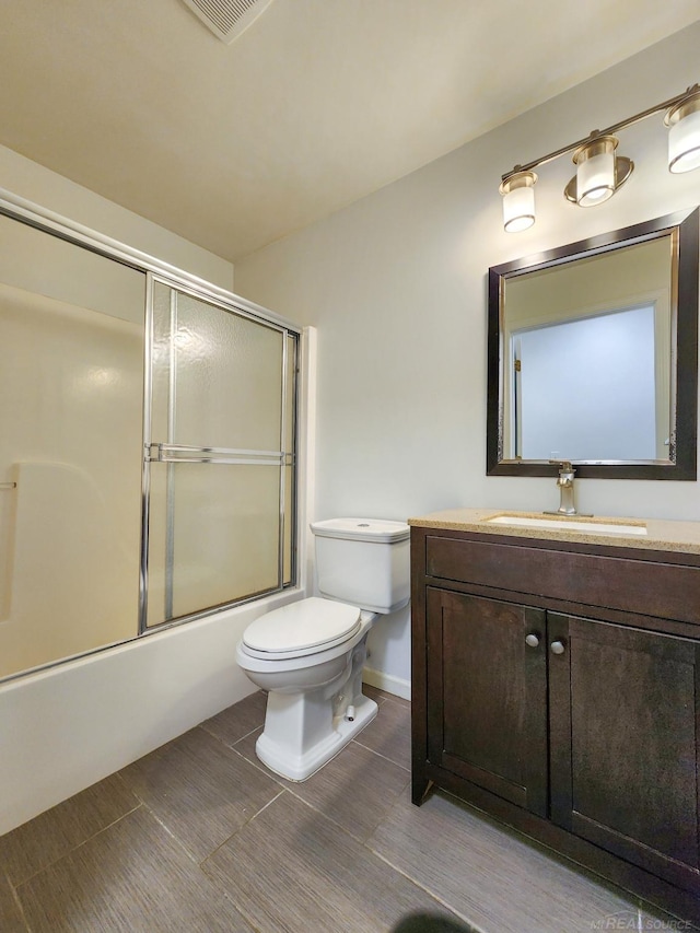 249 Brookwood Dr Unit 4, South Lyon, MI 48178 - full bathroom featuring vanity, toilet, shower / bath combination with glass door, and baseboards
