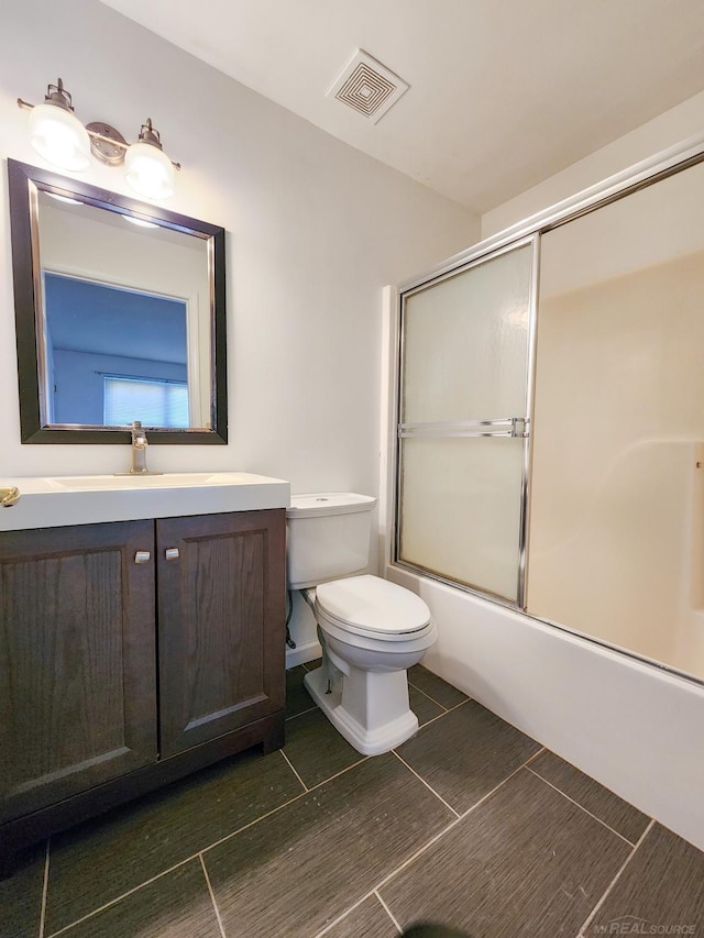 249 Brookwood Dr Unit 4, South Lyon, MI 48178 - full bathroom with vanity, toilet, bath / shower combo with glass door, and tile patterned flooring