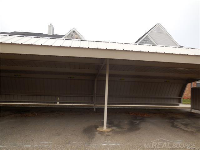 249 Brookwood Dr Unit 4, South Lyon, MI 48178 - garage with covered parking