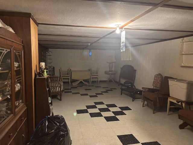73 S Tuscola Rd, Bay City, MI 48708 - finished below grade area featuring tile patterned floors, concrete block wall, and a textured ceiling