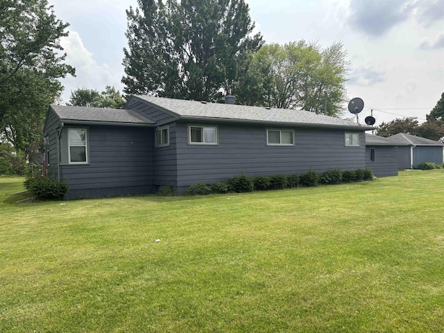 73 S Tuscola Rd, Bay City, MI 48708 - view of side of home featuring a yard and roof with shingles