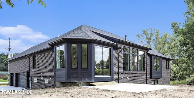 LOT7 Rosy Dr, Leonard, MI 48367 - view of property exterior featuring an attached garage, roof with shingles, and entry steps