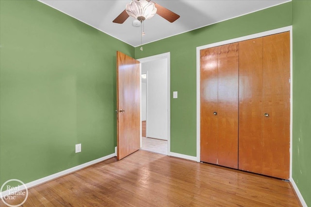 18467 Pershing St, Livonia, MI 48152 - unfurnished bedroom with wood finished floors, baseboards, a closet, and ceiling fan