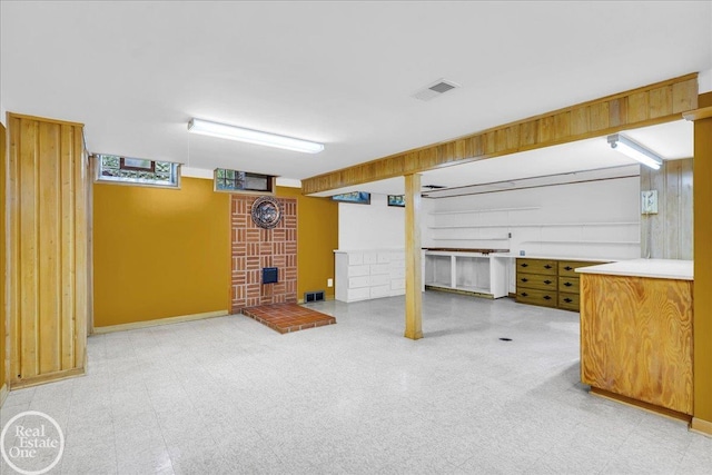 18467 Pershing St, Livonia, MI 48152 - below grade area featuring a brick fireplace, light floors, and baseboards