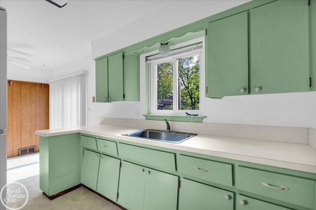 18467 Pershing St, Livonia, MI 48152 - kitchen featuring a sink, light countertops, and green cabinets
