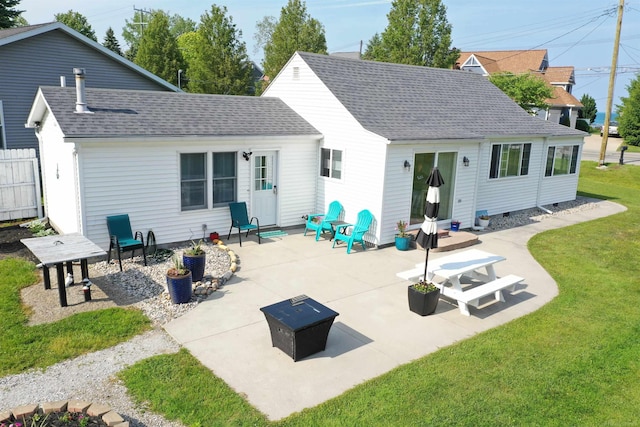 6625 Lakeshore Rd, Lakeport, MI 48059 - back of property with an outdoor fire pit, a lawn, a patio, and a shingled roof