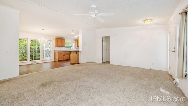 2600 S Hill Rd, Gladstone, MI 49837 - unfurnished living room featuring a chandelier, light carpet, ceiling fan, and a sink