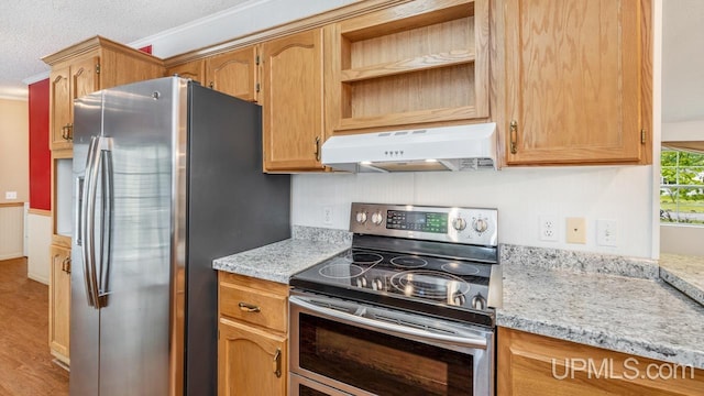 2600 S Hill Rd, Gladstone, MI 49837 - kitchen featuring appliances with stainless steel finishes, under cabinet range hood, light wood-style flooring, light stone countertops, and ornamental molding