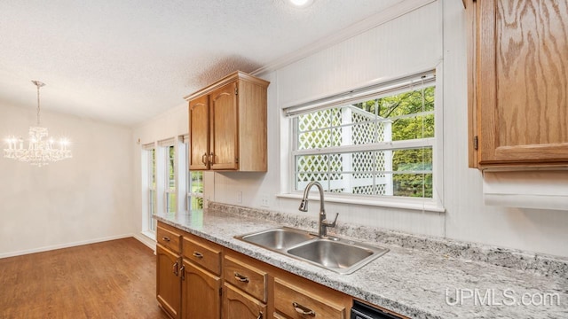 2600 S Hill Rd, Gladstone, MI 49837 - kitchen with a sink, light countertops, plenty of natural light, light wood-style flooring, and a textured ceiling