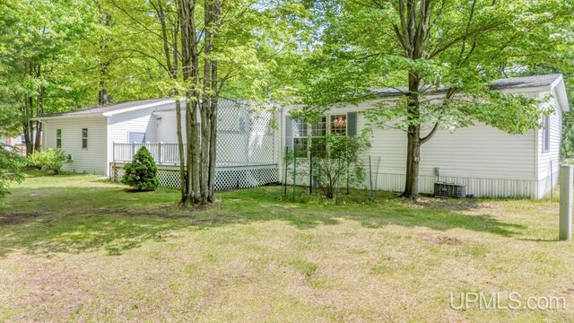 2600 S Hill Rd, Gladstone, MI 49837 - view of grassy yard featuring a wooden deck and central AC