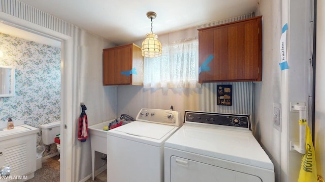 11493 Briarcliff Dr, Warren, MI 48093 - washroom featuring cabinet space, separate washer and dryer, and wallpapered walls