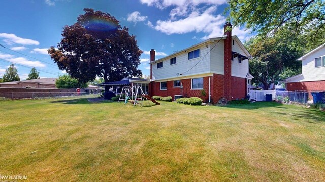 11493 Briarcliff Dr, Warren, MI 48093 - back of property featuring a chimney and brick siding