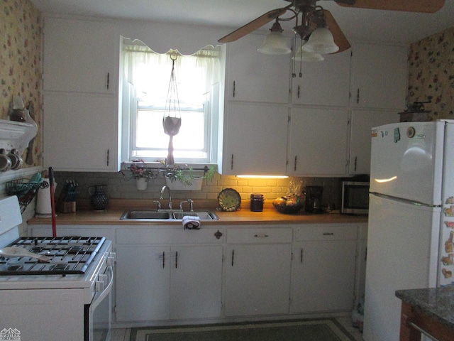 337 N 2nd St, Marine City, MI 48039 - kitchen with white appliances, a sink, ceiling fan, backsplash, and white cabinets