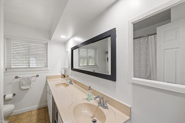13040 Common Rd, Warren, MI 48088 - full bathroom with double vanity, toilet, baseboards, tile patterned floors, and recessed lighting