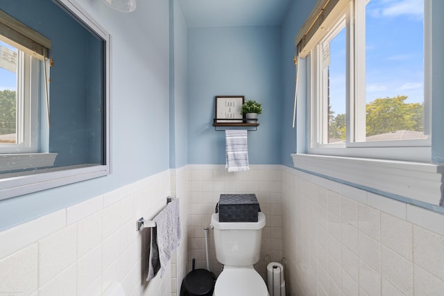 13040 Common Rd, Warren, MI 48088 - half bath with toilet, tile walls, and a wainscoted wall