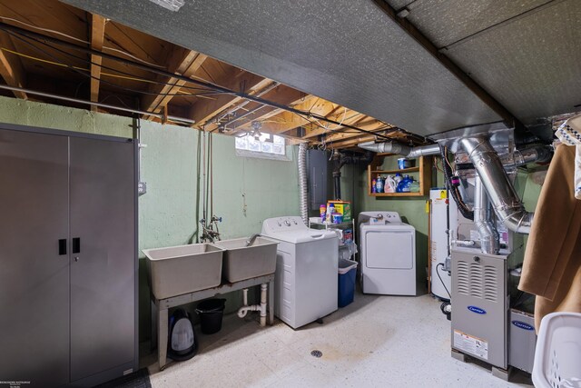 13040 Common Rd, Warren, MI 48088 - below grade area featuring washing machine and dryer, heating unit, and gas water heater