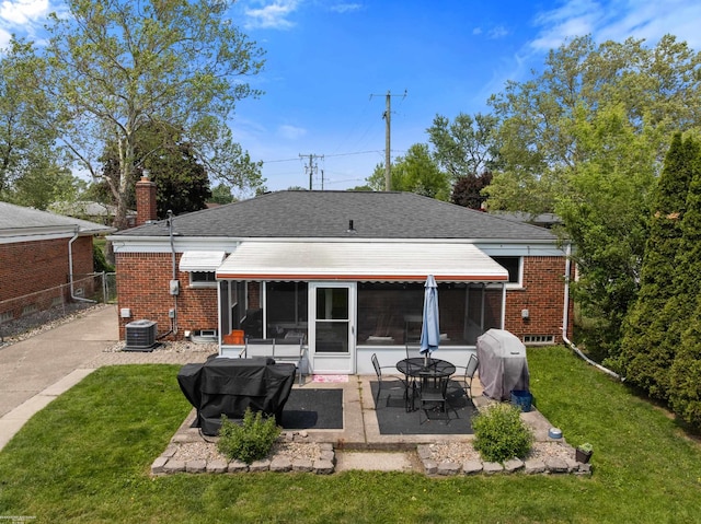 13040 Common Rd, Warren, MI 48088 - rear view of house featuring a patio area, brick siding, a sunroom, and central air condition unit