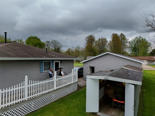 3045 W Lakeside Dr, West Branch, MI 48661 - back of house with roof with shingles and a yard
