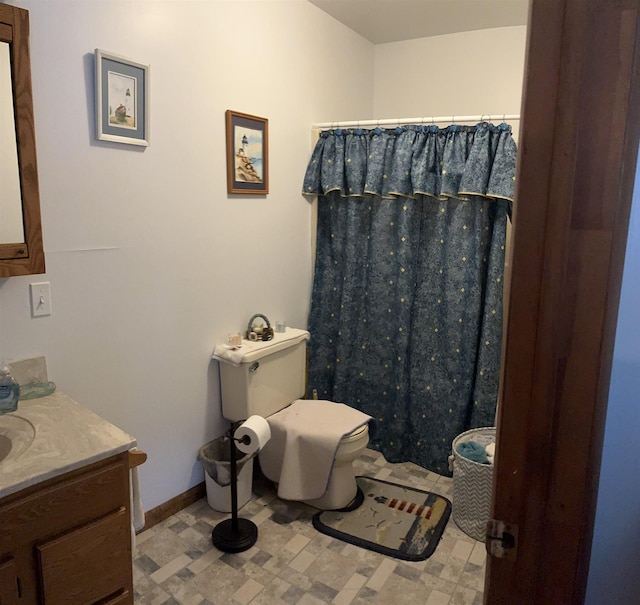 3045 W Lakeside Dr, West Branch, MI 48661 - bathroom with vanity, toilet, tile patterned floors, baseboards, and a shower with shower curtain