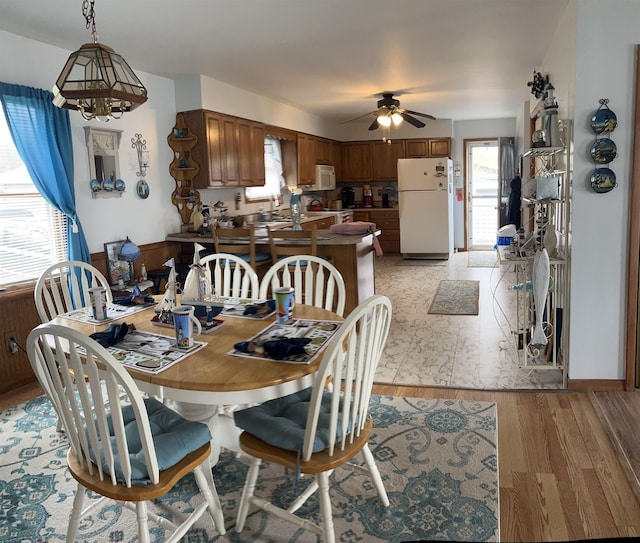 3045 W Lakeside Dr, West Branch, MI 48661 - dining area featuring ceiling fan and light wood-style flooring