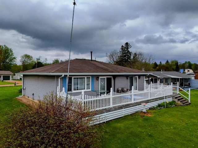 3045 W Lakeside Dr, West Branch, MI 48661 - back of house with a yard and a shingled roof
