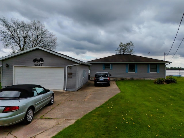 3045 W Lakeside Dr, West Branch, MI 48661 - ranch-style home with a front lawn, concrete driveway, and an outdoor structure