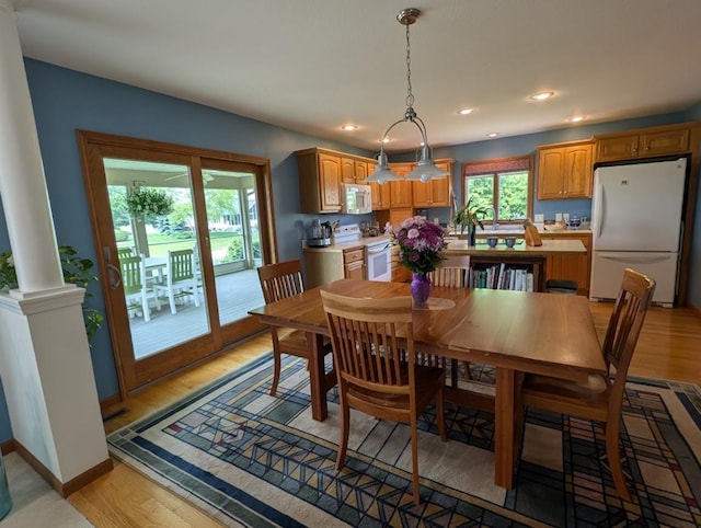 5663 Macintosh Dr, Bay City, MI 48706 - dining space featuring light wood finished floors, ornate columns, and recessed lighting
