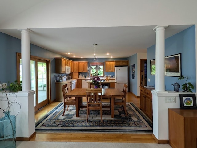 5663 Macintosh Dr, Bay City, MI 48706 - dining area featuring decorative columns, light wood-style floors, and recessed lighting