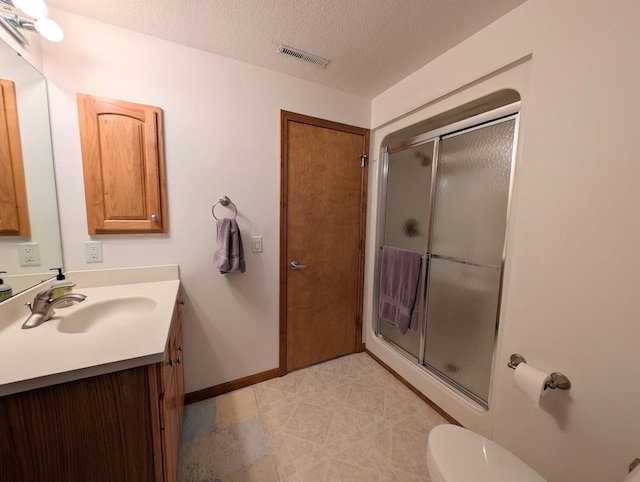 5663 Macintosh Dr, Bay City, MI 48706 - full bath featuring vanity, a shower stall, baseboards, toilet, and a textured ceiling