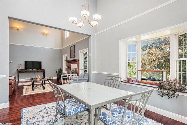 33473 Mulvey Rd, Fraser, MI 48026 - dining room with wood finished floors, a chandelier, baseboards, and a towering ceiling