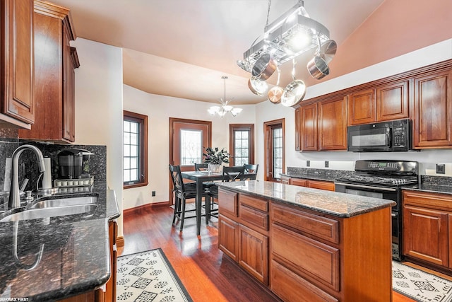33473 Mulvey Rd, Fraser, MI 48026 - kitchen with black appliances, a sink, a kitchen island, wood finished floors, and a chandelier