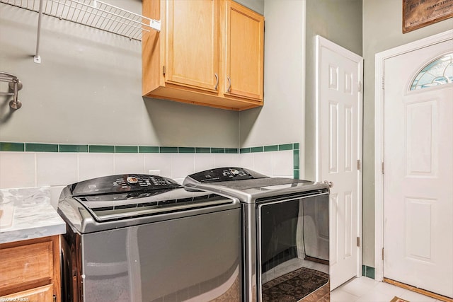 33473 Mulvey Rd, Fraser, MI 48026 - laundry room with cabinet space, washing machine and clothes dryer, and light tile patterned floors