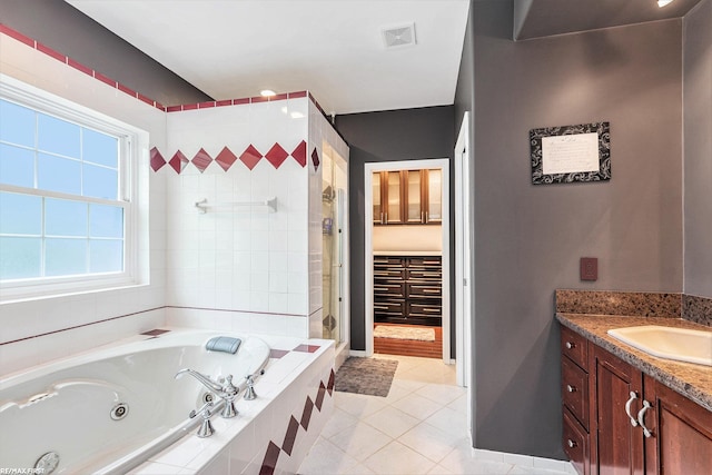 33473 Mulvey Rd, Fraser, MI 48026 - full bath with a whirlpool tub, vanity, tile patterned flooring, tiled shower, and baseboards
