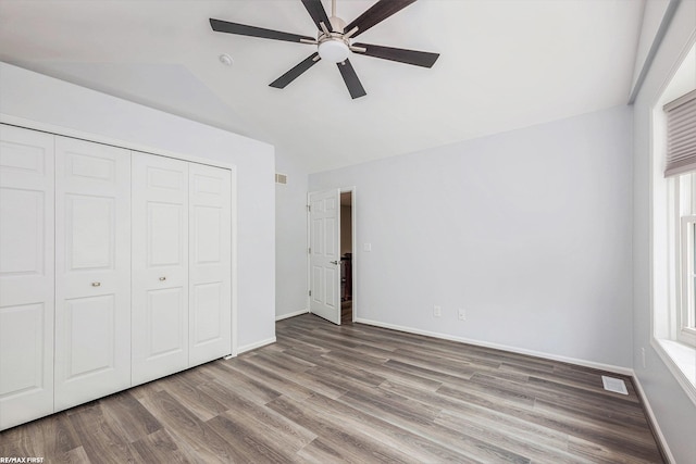 33473 Mulvey Rd, Fraser, MI 48026 - unfurnished bedroom featuring lofted ceiling, wood finished floors, a closet, baseboards, and ceiling fan