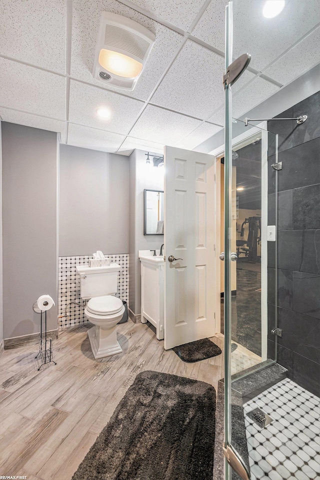 33473 Mulvey Rd, Fraser, MI 48026 - bathroom featuring a stall shower, wood finished floors, toilet, vanity, and a paneled ceiling