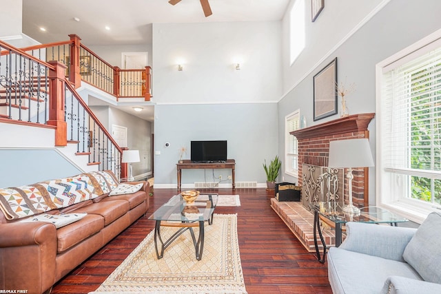 33473 Mulvey Rd, Fraser, MI 48026 - living area with a high ceiling, stairway, a brick fireplace, wood finished floors, and a ceiling fan