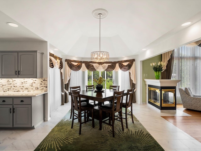 15158 Towering Oaks Dr, Shelby Twp, MI 48315 - dining space featuring a chandelier, light marble finish flooring, recessed lighting, a multi sided fireplace, and baseboards