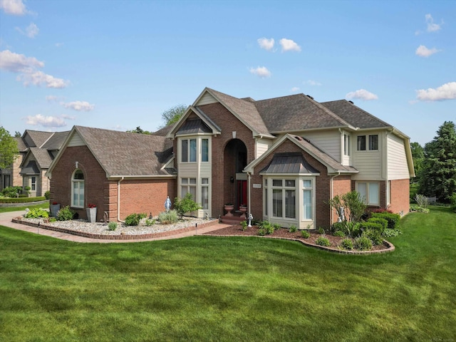 15158 Towering Oaks Dr, Shelby Twp, MI 48315 - view of front of property with brick siding, a front lawn, and a shingled roof