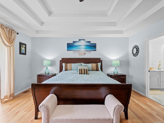 15158 Towering Oaks Dr, Shelby Twp, MI 48315 - bedroom with a raised ceiling, light wood-style flooring, ensuite bath, and baseboards