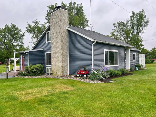 6586 N Coleman Rd, Coleman, MI 48618 - view of home's exterior with a chimney, a lawn, and a cooling unit