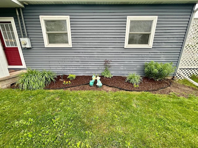 6586 N Coleman Rd, Coleman, MI 48618 - view of home's exterior with a lawn