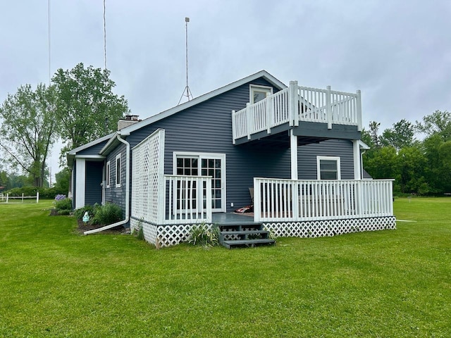 6586 N Coleman Rd, Coleman, MI 48618 - back of property featuring a deck, a lawn, a balcony, and a chimney