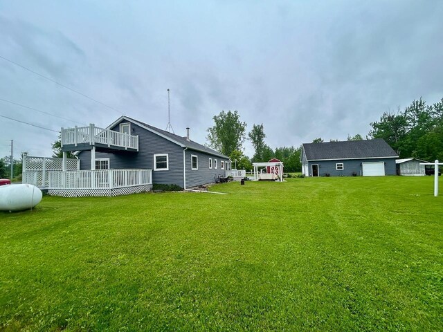 6586 N Coleman Rd, Coleman, MI 48618 - view of green lawn featuring a balcony and a garage