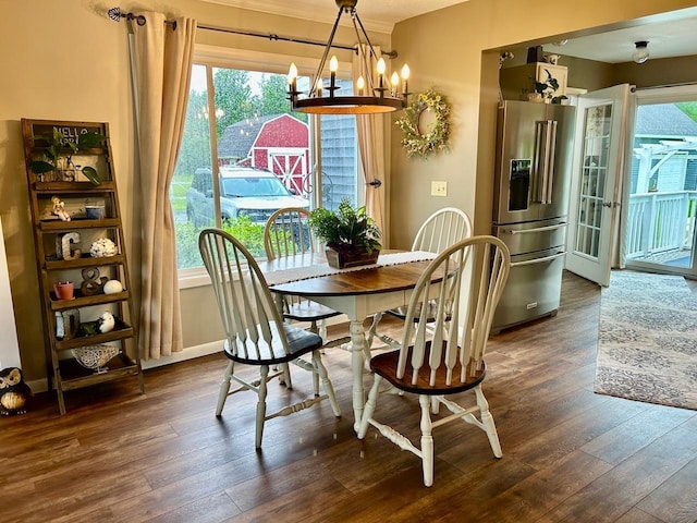 6586 N Coleman Rd, Coleman, MI 48618 - dining space with a chandelier, dark wood finished floors, and baseboards