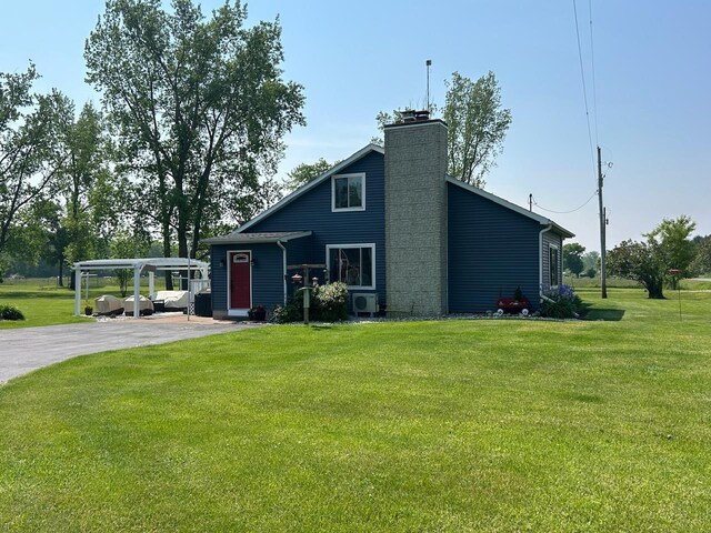 6586 N Coleman Rd, Coleman, MI 48618 - mid-century modern home with a front yard, a chimney, and ac unit