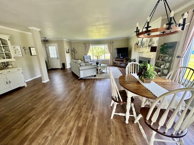 6586 N Coleman Rd, Coleman, MI 48618 - dining space featuring plenty of natural light, dark wood-type flooring, a fireplace, baseboards, and crown molding