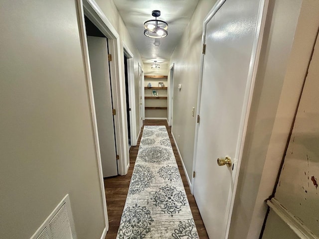 6586 N Coleman Rd, Coleman, MI 48618 - hall with dark wood finished floors and baseboards