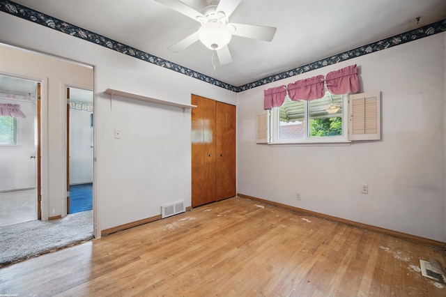 31565 Hayes Rd, Warren, MI 48088 - unfurnished bedroom featuring multiple windows, wood-type flooring, baseboards, and a closet