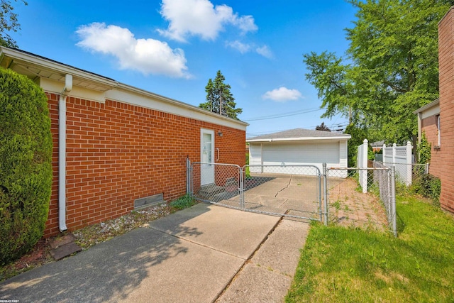 31565 Hayes Rd, Warren, MI 48088 - view of side of property with a gate, brick siding, a garage, and an outdoor structure